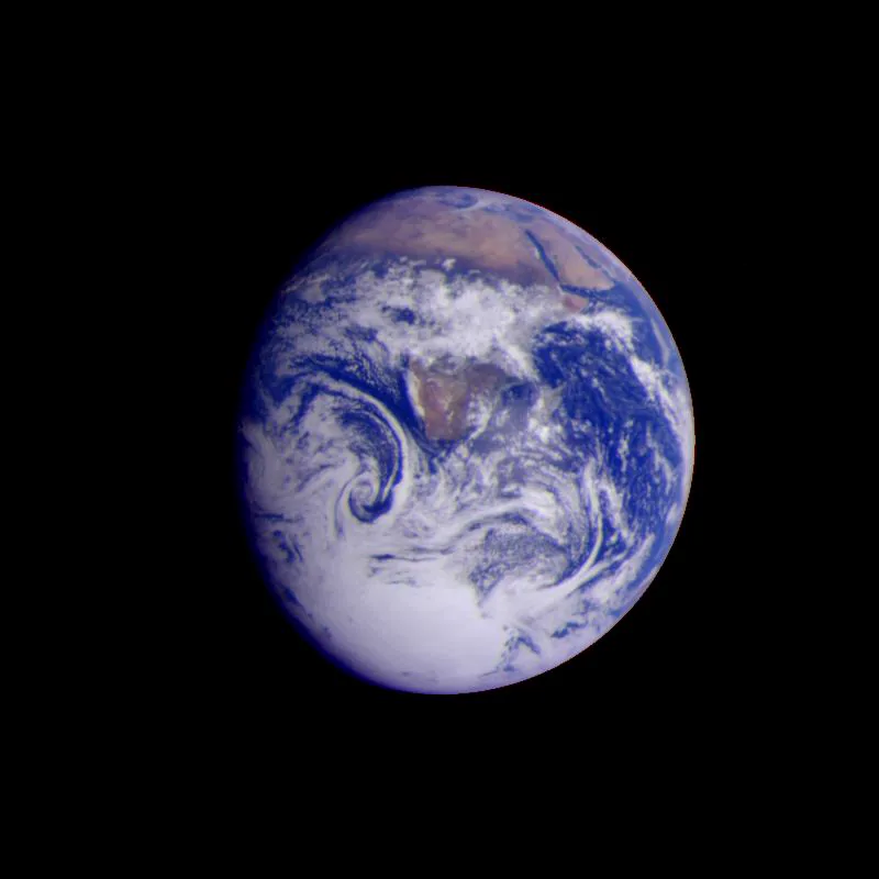Earth as a blue and white disc against black, Africa and the Arabian Peninsula visible through the cloud